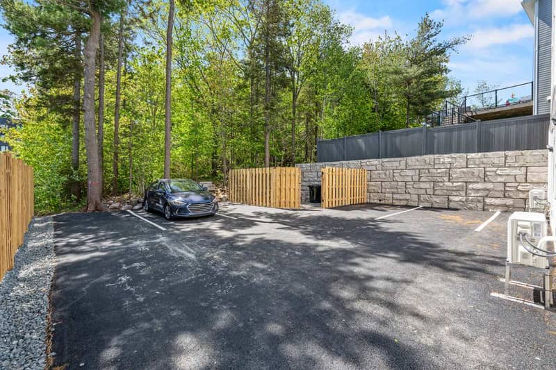 The rear: the parking court, the retaining wall and the fence